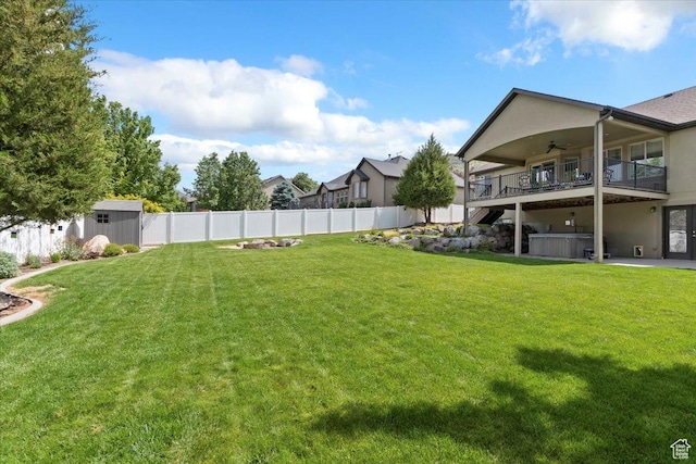 14257 S Round Rock Dr W, Herriman, UT 84096 - fenced backyard with a hot tub, a ceiling fan, and a storage shed