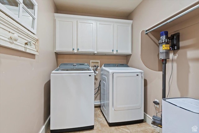 14257 S Round Rock Dr W, Herriman, UT 84096 - washroom featuring separate washer and dryer, cabinet space, and light tile patterned flooring