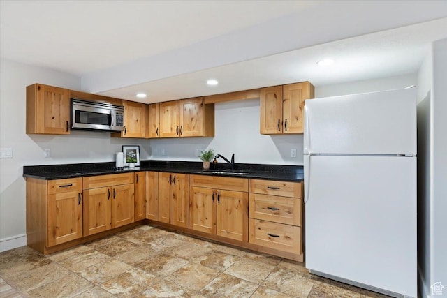 14257 S Round Rock Dr W, Herriman, UT 84096 - kitchen with freestanding refrigerator, stainless steel microwave, stone finish flooring, recessed lighting, and dark stone countertops
