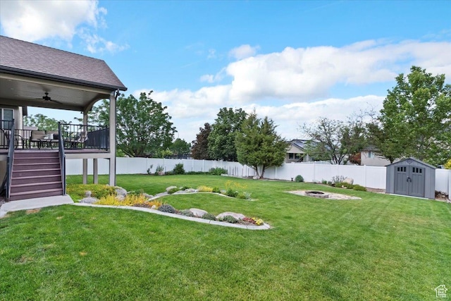 14257 S Round Rock Dr W, Herriman, UT 84096 - fenced backyard featuring a fire pit, a shed, a ceiling fan, a wooden deck, and stairway