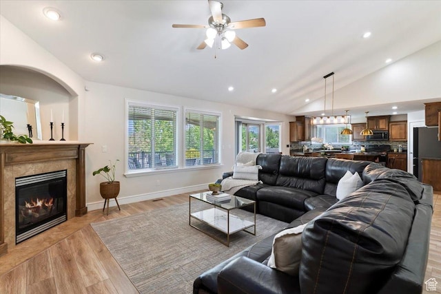 14257 S Round Rock Dr W, Herriman, UT 84096 - living area with lofted ceiling, a ceiling fan, a high end fireplace, recessed lighting, and light wood-style flooring