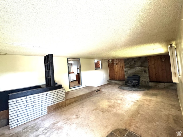 240 E 300 S, Kamas, UT 84036 - unfurnished living room with a wood stove, a textured ceiling, and carpet floors