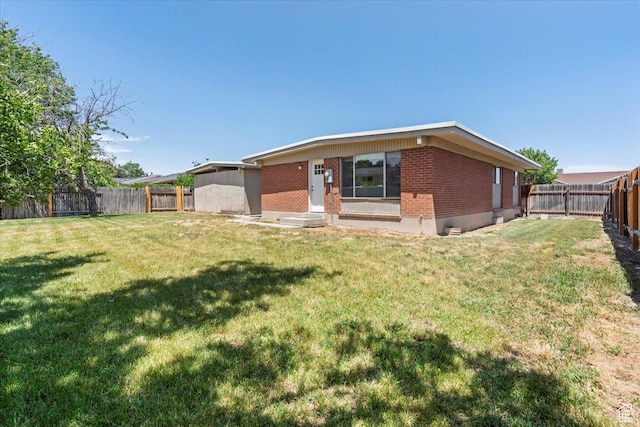 3705 W 3800 S, West Valley City, UT 84120 - rear view of house featuring brick siding and a fenced backyard