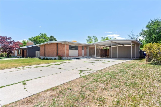 3705 W 3800 S, West Valley City, UT 84120 - view of front of house with driveway, brick siding, a carport, and a chimney