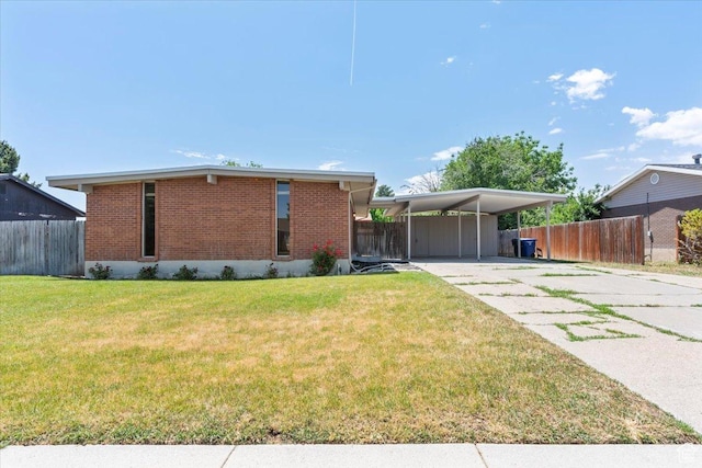 3705 W 3800 S, West Valley City, UT 84120 - back of house with brick siding, driveway, and an attached carport
