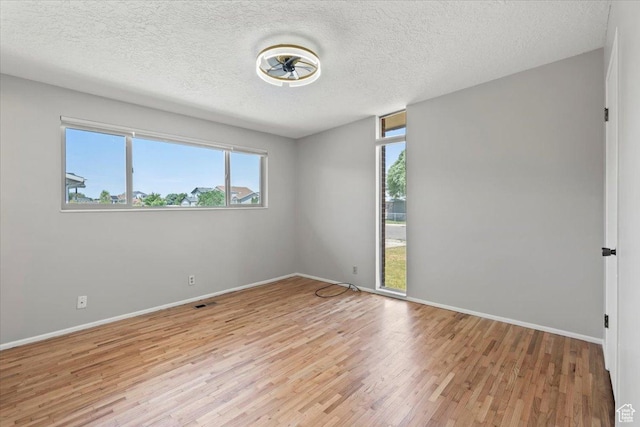 3705 W 3800 S, West Valley City, UT 84120 - unfurnished room with light wood-style flooring and a textured ceiling
