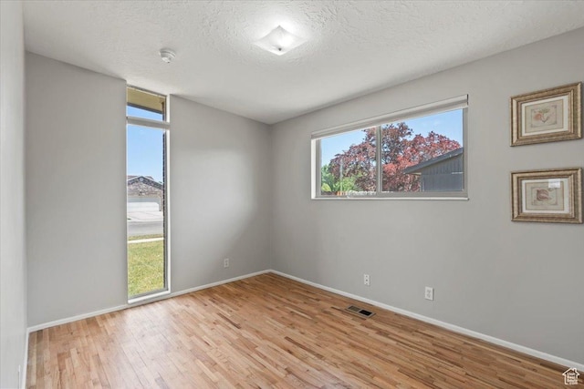 3705 W 3800 S, West Valley City, UT 84120 - unfurnished room with wood finished floors, a smoke detector, and a textured ceiling