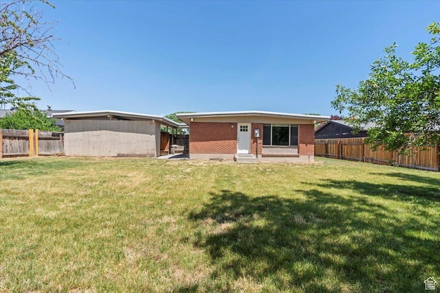 3705 W 3800 S, West Valley City, UT 84120 - back of property with entry steps, a fenced backyard, and brick siding
