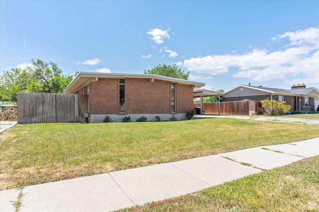 3705 W 3800 S, West Valley City, UT 84120 - view of side of property featuring brick siding and an attached carport