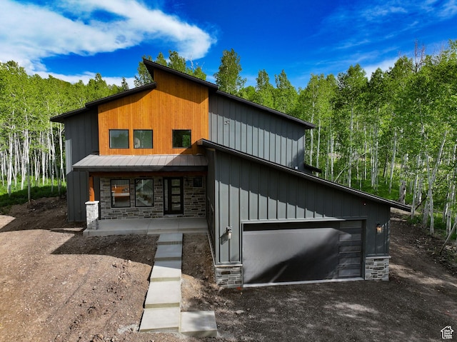 11234 E Columbine Ln, Heber City, UT 84032 - contemporary home with stone siding, dirt driveway, a metal roof, and board and batten siding