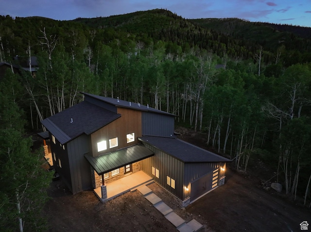 11234 E Columbine Ln, Heber City, UT 84032 - back of property featuring a view of trees, a standing seam roof, roof with shingles, and a metal roof