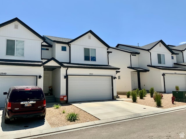 2953 W Ezra Dr, Cedar City, UT 84720 - view of front facade featuring a garage, driveway, and board and batten siding
