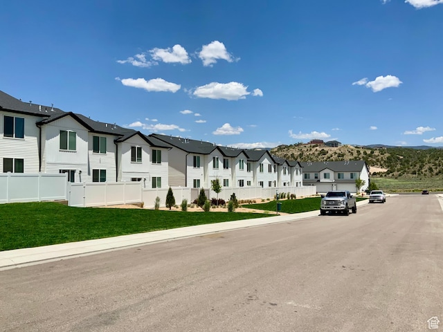 2953 W Ezra Dr, Cedar City, UT 84720 - view of asphalt road with a residential view, sidewalks, and curbs