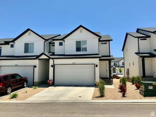 2953 W Ezra Dr, Cedar City, UT 84720 - view of front facade featuring an attached garage, concrete driveway, and board and batten siding