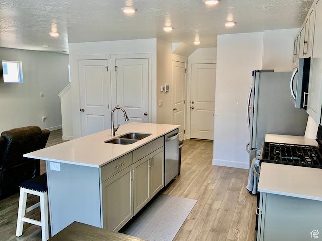 2953 W Ezra Dr, Cedar City, UT 84720 - kitchen with stainless steel appliances, light wood-style floors, light countertops, gray cabinets, and recessed lighting