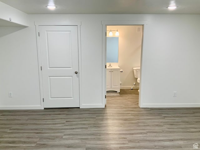 2953 W Ezra Dr, Cedar City, UT 84720 - unfurnished bedroom with wood finished floors, connected bathroom, and recessed lighting