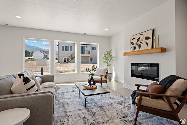 1324 E 320 S, Payson, UT 84651 - living area featuring a glass covered fireplace, wood finished floors, healthy amount of natural light, and recessed lighting