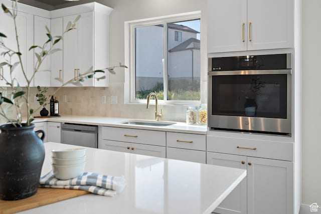 1324 E 320 S, Payson, UT 84651 - kitchen featuring appliances with stainless steel finishes, light countertops, white cabinets, and backsplash