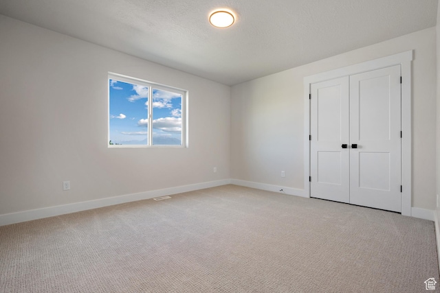 1324 E 320 S, Payson, UT 84651 - unfurnished bedroom with light colored carpet, a closet, and a textured ceiling