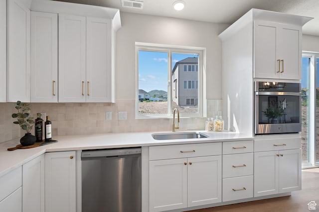 1324 E 320 S, Payson, UT 84651 - kitchen with stainless steel appliances, white cabinetry, tasteful backsplash, and light countertops