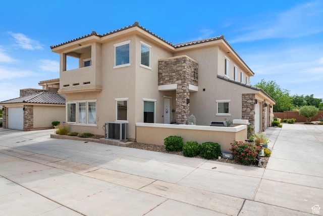 140 W Center St Unit 29, Ivins, UT 84738 - view of front of home featuring driveway, stone siding, stucco siding, a garage, and a tiled roof