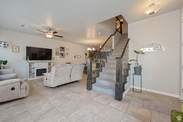 140 W Center St Unit 29, Ivins, UT 84738 - living area featuring stairs, light tile patterned flooring, a fireplace, ceiling fan, and a chandelier