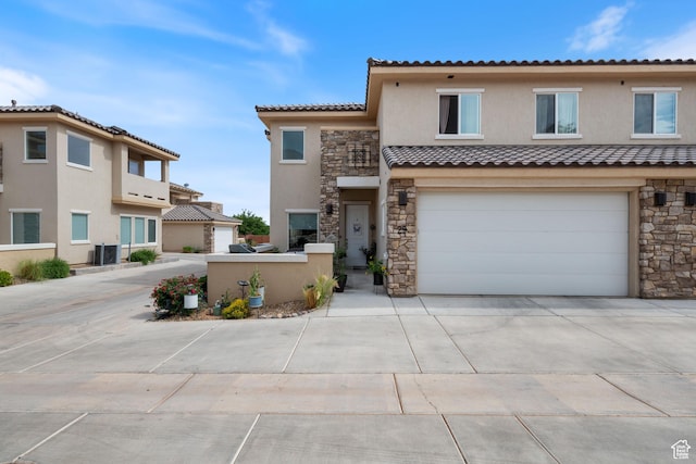 140 W Center St Unit 29, Ivins, UT 84738 - townhome / multi-family property featuring stone siding, stucco siding, driveway, a tile roof, and a garage