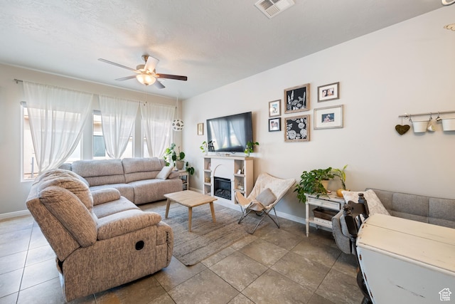 140 W Center St Unit 29, Ivins, UT 84738 - living room featuring a ceiling fan and a glass covered fireplace