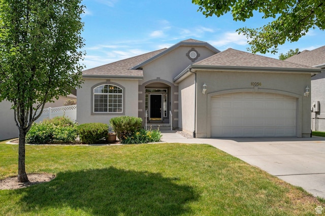 10056 S Remembrance Ln, South Jordan, UT 84095 - view of front facade with a garage, stucco siding, concrete driveway, and roof with shingles