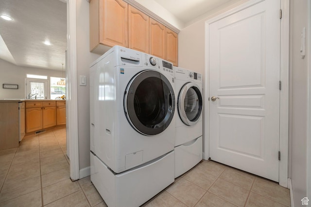 10056 S Remembrance Ln, South Jordan, UT 84095 - laundry room with washing machine and clothes dryer, light tile patterned flooring, recessed lighting, and cabinet space