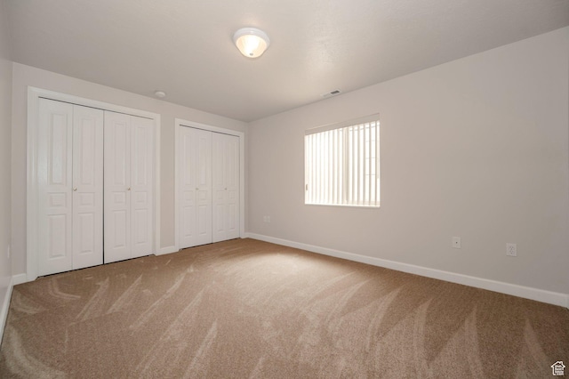 10056 S Remembrance Ln, South Jordan, UT 84095 - unfurnished bedroom featuring two closets and carpet flooring