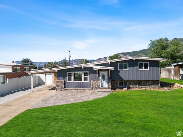 790 E 5300 S, South Ogden, UT 84405 - split level home featuring an attached carport, a mountain view, stone siding, driveway, and board and batten siding
