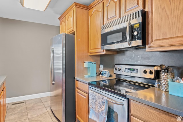 790 E 5300 S, South Ogden, UT 84405 - kitchen featuring appliances with stainless steel finishes, light tile patterned floors, and light brown cabinets