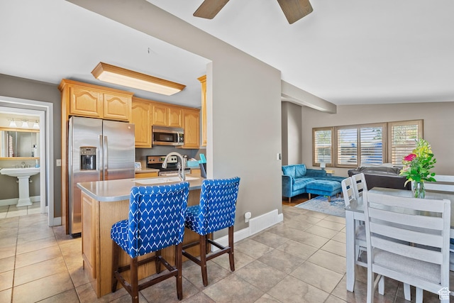 790 E 5300 S, South Ogden, UT 84405 - kitchen featuring stainless steel appliances, light countertops, open floor plan, light tile patterned floors, and light brown cabinetry