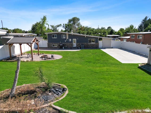 790 E 5300 S, South Ogden, UT 84405 - rear view of house with a gazebo, an outdoor fire pit, a patio area, a fenced backyard, and stone siding