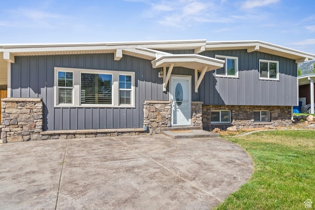 790 E 5300 S, South Ogden, UT 84405 - view of front facade featuring board and batten siding, a front yard, and a patio
