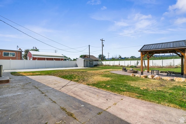 790 E 5300 S, South Ogden, UT 84405 - fenced backyard featuring a fire pit, a gazebo, a patio area, and a storage unit