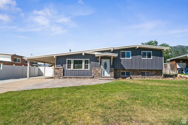 790 E 5300 S, South Ogden, UT 84405 - view of front of home with a carport, concrete driveway, stone siding, a patio area, and board and batten siding
