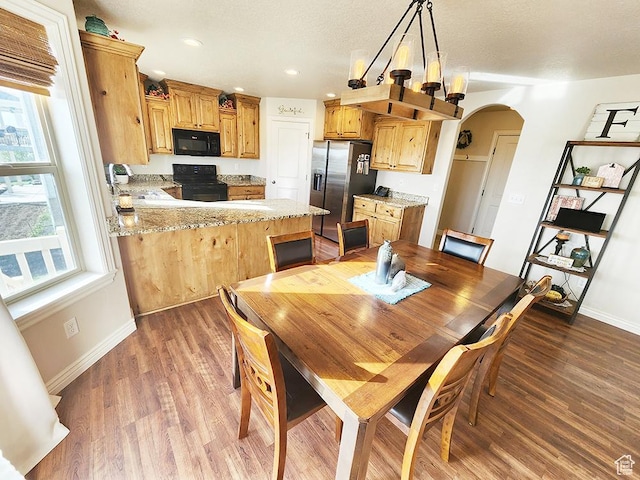1365 N Highland Blvd, Brigham City, UT 84302 - dining room with arched walkways, wood finished floors, and recessed lighting