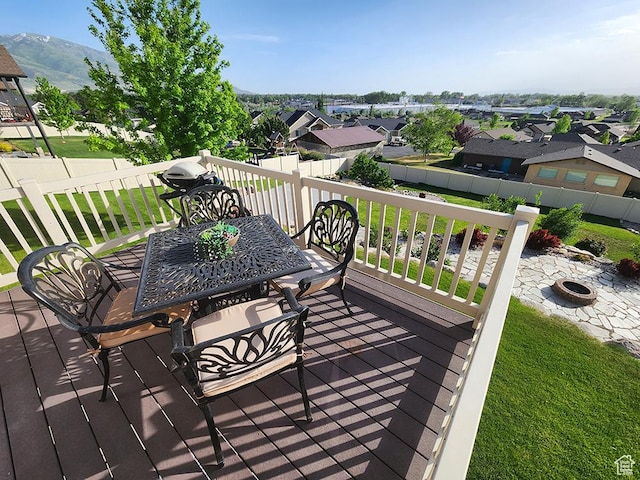 1365 N Highland Blvd, Brigham City, UT 84302 - wooden terrace featuring an outdoor fire pit, a mountain view, a yard, and a residential view