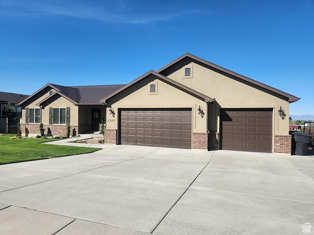 1365 N Highland Blvd, Brigham City, UT 84302 - ranch-style house featuring brick siding, an attached garage, driveway, stucco siding, and a front lawn