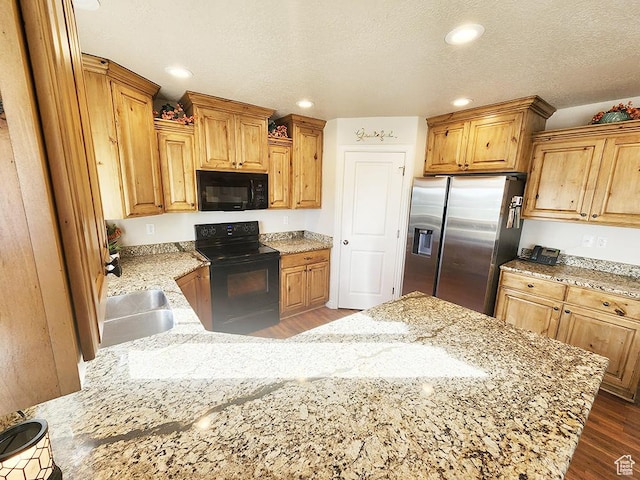 1365 N Highland Blvd, Brigham City, UT 84302 - kitchen featuring black appliances, a peninsula, light stone counters, dark wood finished floors, and recessed lighting