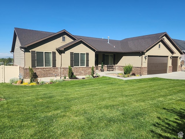 1365 N Highland Blvd, Brigham City, UT 84302 - ranch-style home featuring brick siding, a garage, concrete driveway, and stucco siding