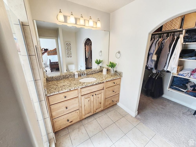 1365 N Highland Blvd, Brigham City, UT 84302 - bathroom with vanity, a spacious closet, and tile patterned flooring