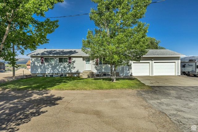 501 N Main St, Vernon, UT 84080 - view of front of home with concrete driveway, entry steps, an attached garage, a front lawn, and roof with shingles