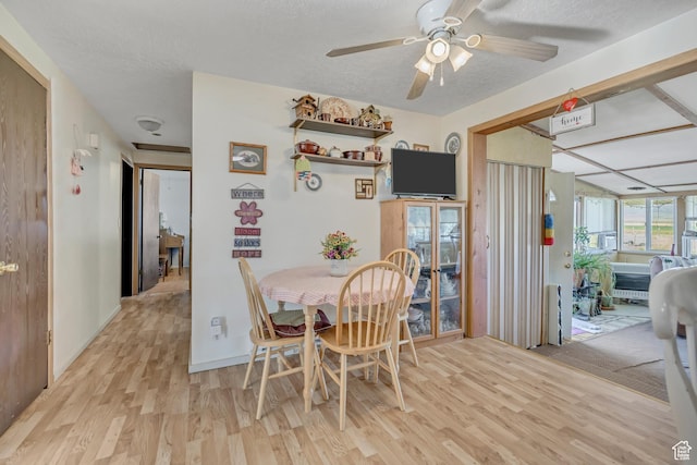 501 N Main St, Vernon, UT 84080 - dining space with light wood finished floors, a ceiling fan, and a textured ceiling