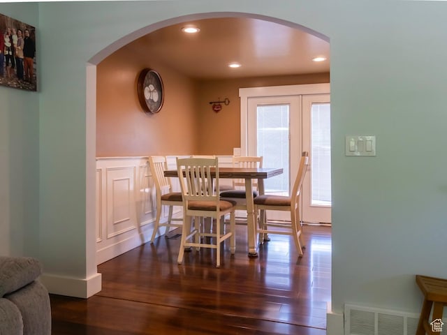 2970 S Mock Orange Dr W, West Valley City, UT 84119 - dining space featuring arched walkways, dark wood-style flooring, recessed lighting, french doors, and wainscoting