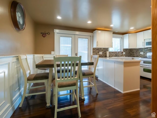 2970 S Mock Orange Dr W, West Valley City, UT 84119 - dining area featuring dark wood-style floors, french doors, a decorative wall, recessed lighting, and wainscoting