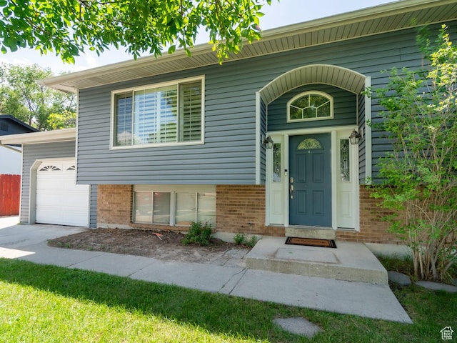 2970 S Mock Orange Dr W, West Valley City, UT 84119 - view of front of property featuring brick siding and a garage