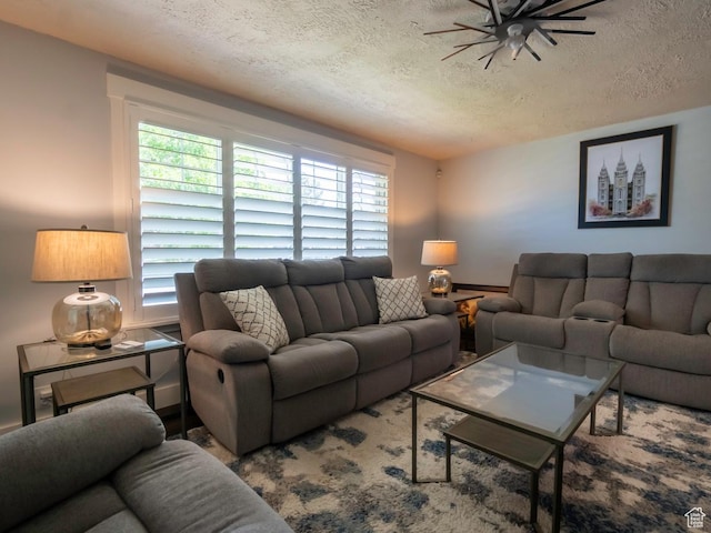 2970 S Mock Orange Dr W, West Valley City, UT 84119 - living area featuring a textured ceiling, plenty of natural light, and a ceiling fan